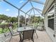 Enjoy relaxing in this screened patio, featuring a table and chairs, perfect for outdoor dining at 1315 Greenville Way, The Villages, FL 32162