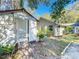 Small shed and a portion of the house in a tree-filled backyard at 1415 E 9Th Ave, Mount Dora, FL 32757