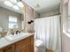 Well-lit bathroom with single sink vanity, shower, and toilet at 1415 E 9Th Ave, Mount Dora, FL 32757