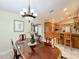 Dining room with chandelier and view into the kitchen and living area at 1415 E 9Th Ave, Mount Dora, FL 32757