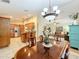 Dining room with chandelier, and view into the kitchen and living room at 1415 E 9Th Ave, Mount Dora, FL 32757