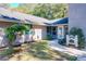 Landscaped entryway with a fountain leading to the front door at 1415 E 9Th Ave, Mount Dora, FL 32757