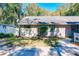 Side view of the house with a fountain and lush green landscaping at 1415 E 9Th Ave, Mount Dora, FL 32757