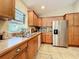 Kitchen with wood cabinets, stainless steel appliances, and ample counter space at 1415 E 9Th Ave, Mount Dora, FL 32757