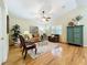 Living room with hardwood floors, ceiling fan, and comfortable seating at 1415 E 9Th Ave, Mount Dora, FL 32757