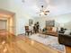 Living room with hardwood floors, ceiling fan, and comfortable seating at 1415 E 9Th Ave, Mount Dora, FL 32757