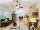 Living room with hardwood floors, ceiling fan, and view into dining area at 1415 E 9Th Ave, Mount Dora, FL 32757