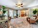 Sunroom featuring wicker chairs, a rug, and access to the kitchen at 1415 E 9Th Ave, Mount Dora, FL 32757