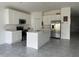 Modern kitchen with white cabinets, stainless steel appliances, and an island at 361 Singing Sands Cir, Lake Wales, FL 33859