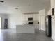 Open concept kitchen with white cabinets and a large island at 361 Singing Sands Cir, Lake Wales, FL 33859