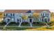 Charming townhomes feature colorful exteriors, inviting front porches and lush landscaping, creating a welcoming community atmosphere at 561 Juniper Springs Dr, Groveland, FL 34736