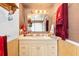 Classic bathroom featuring a vanity with drawers, a mirror, and stylish lighting at 1214 Loch Rannoch Ct, Leesburg, FL 34788