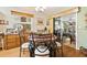 Charming dining room with a round table, and natural light from sliding glass door at 1214 Loch Rannoch Ct, Leesburg, FL 34788