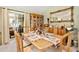 Elegant dining room featuring a wooden table, hutch, and a large mirror at 1214 Loch Rannoch Ct, Leesburg, FL 34788