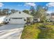Charming single-story home featuring a well-manicured lawn and attached two car garage at 1214 Loch Rannoch Ct, Leesburg, FL 34788