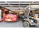 Spacious two car garage featuring a car and a golf cart at 1214 Loch Rannoch Ct, Leesburg, FL 34788