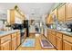 Eat-in kitchen featuring light wood cabinets, laminate countertop, modern appliances, and hardwood floors at 1214 Loch Rannoch Ct, Leesburg, FL 34788