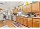 Well-lit kitchen with white appliances, updated sink fixtures, and hardwood floors at 1214 Loch Rannoch Ct, Leesburg, FL 34788