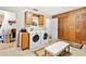 Well-equipped laundry room with washer, dryer, and plenty of storage space at 1214 Loch Rannoch Ct, Leesburg, FL 34788