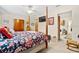 Comfortable main bedroom featuring ceiling fan, TV, and access to the laundry room at 1214 Loch Rannoch Ct, Leesburg, FL 34788
