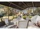 Outdoor patio with ample seating and views of the landscaped backyard at 1214 Loch Rannoch Ct, Leesburg, FL 34788