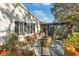 Backyard patio with flowering plants and access to a screened in porch at 1214 Loch Rannoch Ct, Leesburg, FL 34788