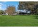 Expansive backyard with mature trees providing shade and privacy at 21502 King Henry Ave, Leesburg, FL 34748