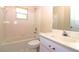 Clean, well-lit bathroom with white fixtures including a tub/shower combo and vanity at 21502 King Henry Ave, Leesburg, FL 34748