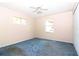 Simple bedroom with a ceiling fan, two windows, a closet, and plain walls at 21502 King Henry Ave, Leesburg, FL 34748