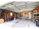 Spacious garage with ample storage and a variety of tools and equipment at 21502 King Henry Ave, Leesburg, FL 34748
