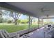 Relaxing screened lanai with comfortable seating and serene views of the expansive backyard at 21502 King Henry Ave, Leesburg, FL 34748