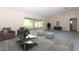 Bright living room featuring neutral walls, plush seating, and sliding doors to the screened-in lanai at 21502 King Henry Ave, Leesburg, FL 34748
