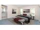 Cozy main bedroom featuring two windows, two side tables with lamps, and a bathroom entrance at 21502 King Henry Ave, Leesburg, FL 34748
