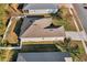 This aerial view displays the roofline, side yard, and proximity to neighboring houses of this lovely home at 2354 Valhalla Dr, Tavares, FL 32778