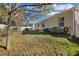 A home's backyard with a well-maintained lawn and partial fence in the back at 2354 Valhalla Dr, Tavares, FL 32778