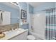 Stylish bathroom featuring a tiled sink backsplash, white cabinetry and tub with shower at 2354 Valhalla Dr, Tavares, FL 32778