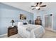 Bedroom with a ceiling fan, a white metal bed frame, and an adjacent bathroom entrance at 2354 Valhalla Dr, Tavares, FL 32778