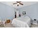 Comfortable bedroom with blue walls, carpet, ceiling fan, and natural light at 2354 Valhalla Dr, Tavares, FL 32778