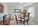 Inviting dining room featuring a glass table, wood chairs, and natural light from the window at 2354 Valhalla Dr, Tavares, FL 32778