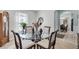 Cozy dining area with a round glass table, four chairs, and view to Kitchen at 2354 Valhalla Dr, Tavares, FL 32778