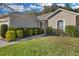 Landscaped front yard with vibrant, well-maintained bushes and healthy green lawn at 2354 Valhalla Dr, Tavares, FL 32778