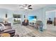 Bright living room featuring recessed lighting, modern flooring, and a sliding glass door at 2354 Valhalla Dr, Tavares, FL 32778