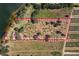 Stunning aerial view of a sprawling property with a picturesque lakefront setting and fruit orchard at 38230 Yale Cir, Leesburg, FL 34788