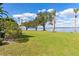 Lush green lawn and mature trees meet serene lake views in this tranquil backyard oasis at 38230 Yale Cir, Leesburg, FL 34788