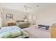 Bright bedroom with two beds, ensuite bathroom, neutral walls, and a ceiling fan at 38230 Yale Cir, Leesburg, FL 34788