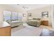 Bedroom featuring carpet floors, a ceiling fan, and lake views at 38230 Yale Cir, Leesburg, FL 34788