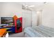 Colorful bedroom with a bed, tv, storage, and a ceiling fan at 38230 Yale Cir, Leesburg, FL 34788