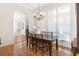 Dining room featuring a chandelier, a wooden table with six chairs and large windows at 38230 Yale Cir, Leesburg, FL 34788
