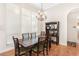 Dining room featuring a chandelier, a wooden table with six chairs and large windows at 38230 Yale Cir, Leesburg, FL 34788