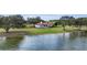 Stunning lakefront home with a lush lawn, mature trees and a red tile roof at 38230 Yale Cir, Leesburg, FL 34788
